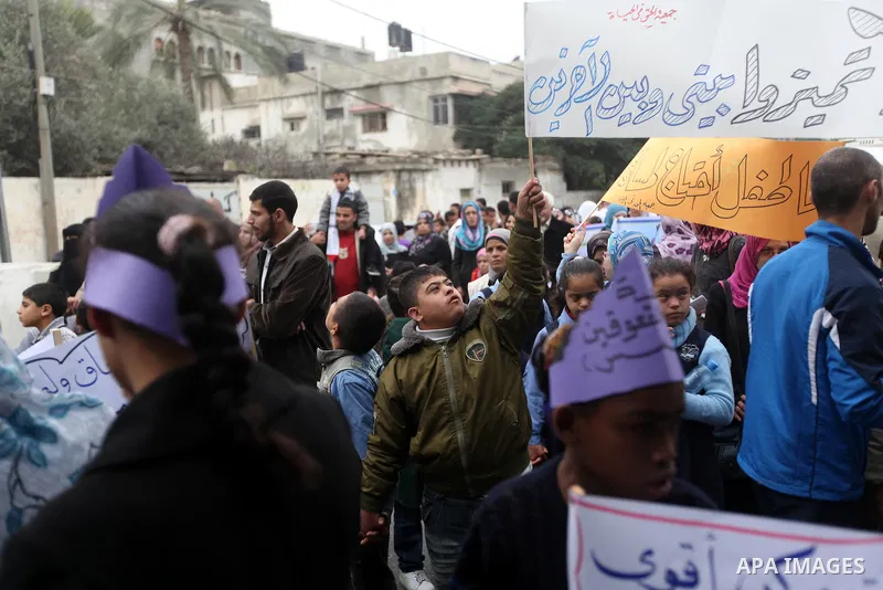 Palestinian children with special needs walk past buildings destroyed during the Gaza-Israeli conflict during a demonstration on the occasion of the UN International Day of People with Disability, on December 4, 2012 in...