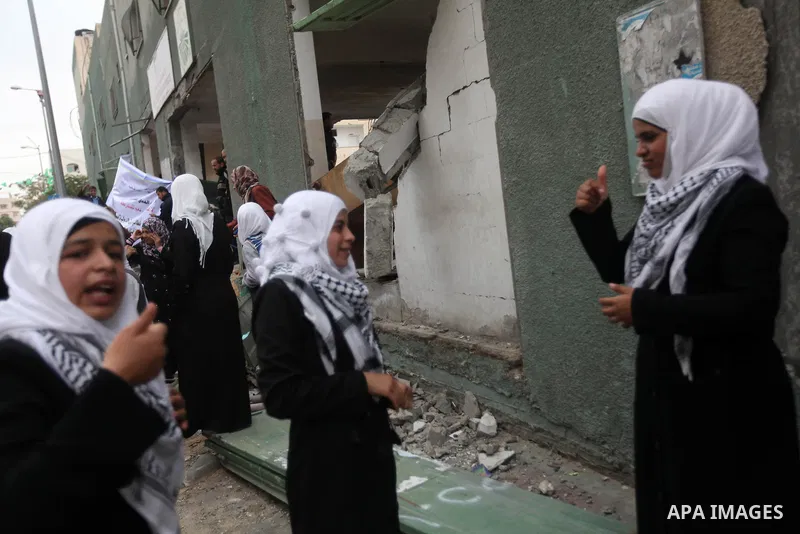 Palestinian children with special needs walk past buildings destroyed during the Gaza-Israeli conflict during a demonstration on the occasion of the UN International Day of People with Disability, on December 4, 2012 in...