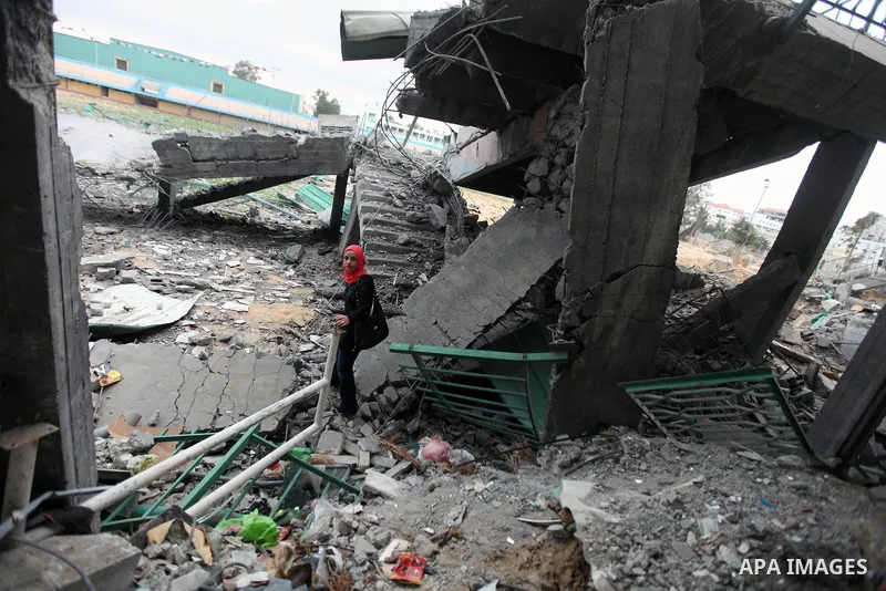 Palestinian children with special needs walk past buildings destroyed during the Gaza-Israeli conflict during a demonstration on the occasion of the UN International Day of People with Disability, on December 4, 2012 in...