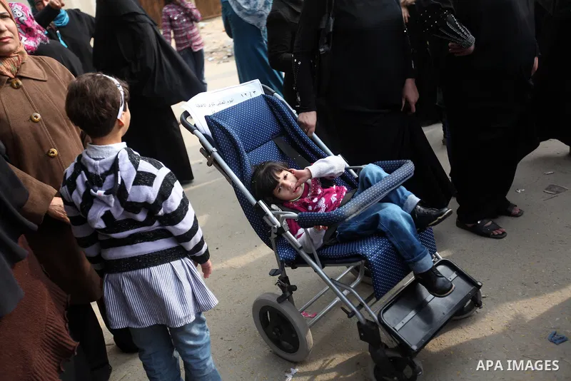 Palestinian children with special needs walk past buildings destroyed during the Gaza-Israeli conflict during a demonstration on the occasion of the UN International Day of People with Disability, on December 4, 2012 in...