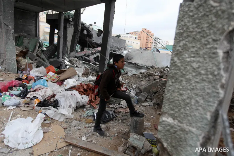 Palestinian children with special needs walk past buildings destroyed during the Gaza-Israeli conflict during a demonstration on the occasion of the UN International Day of People with Disability, on December 4, 2012 in...
