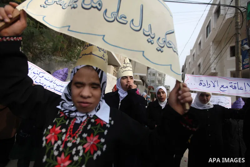 Palestinian children with special needs walk past buildings destroyed during the Gaza-Israeli conflict during a demonstration on the occasion of the UN International Day of People with Disability, on December 4, 2012 in...