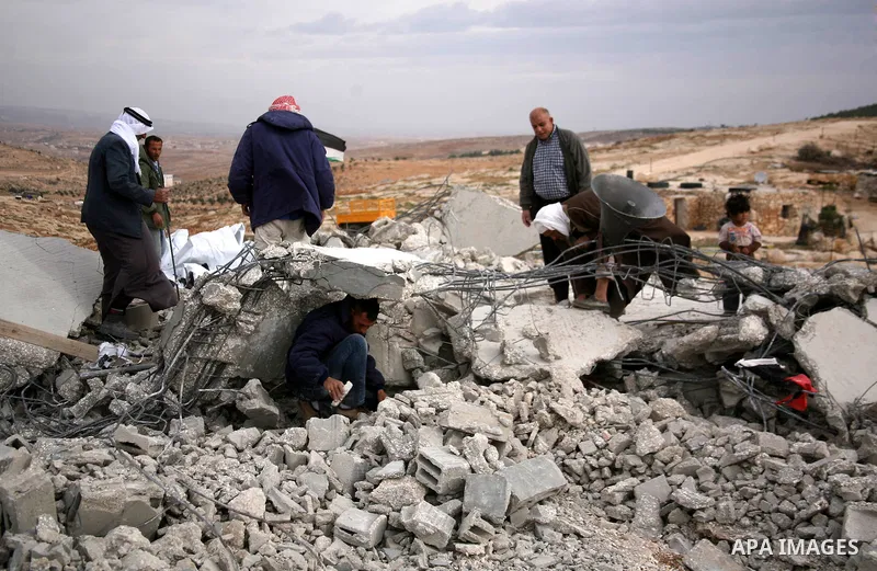 Palestinian men search through the rubble of a mosque that was demolished by Israeli forces in the West Bank village of al-Mufaqara, south of Hebron, on December 04, 2012. Photo by Mamoun Wazwaz
