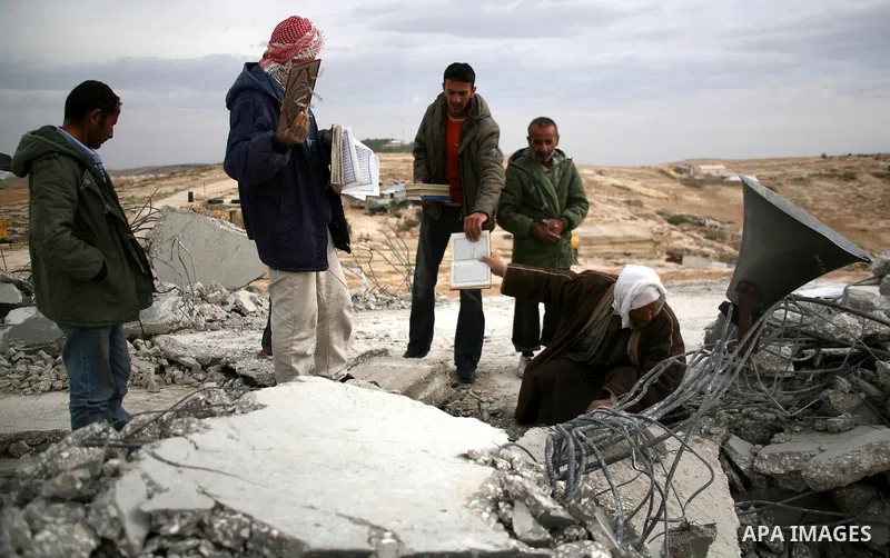 Palestinian men search through the rubble of a mosque that was demolished by Israeli forces in the West Bank village of al-Mufaqara, south of Hebron, on December 04, 2012. Photo by Mamoun Wazwaz