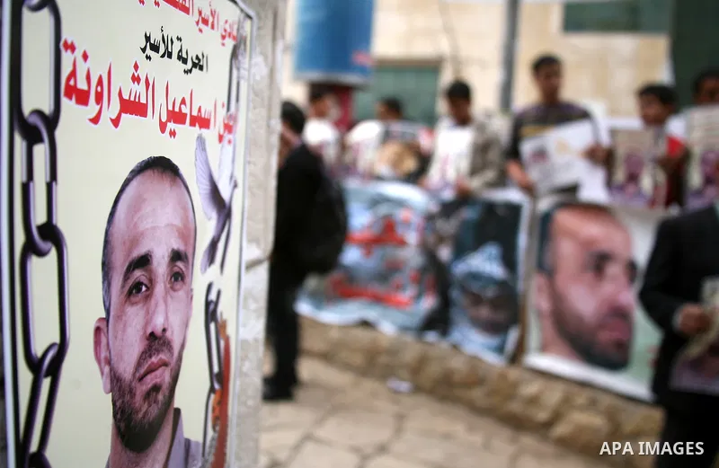 Palestinians shout slogans during a protest in the West Bank city of Hebron on Dec. 04, 2012 in solidarity with the prisoners on hunger strike for nearly four months in Israeli jails. Photo by Mamoun Wazwaz