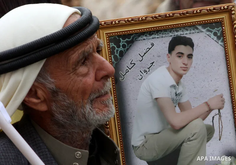 Palestinians hold pictures of their prisoned relatives in Israeli jails as they gather in a weekly activity calling for their liberty at the Red Cross headquarters in the West Bank city of Nablus on December 04, 2012. Ph...
