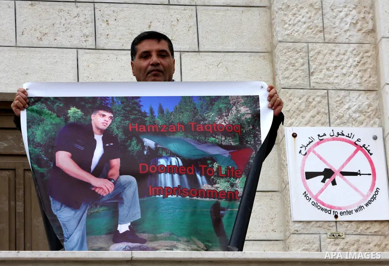 Palestinians hold pictures of their prisoned relatives in Israeli jails as they gather in a weekly activity calling for their liberty at the Red Cross headquarters in the West Bank city of Nablus on December 04, 2012. Ph...