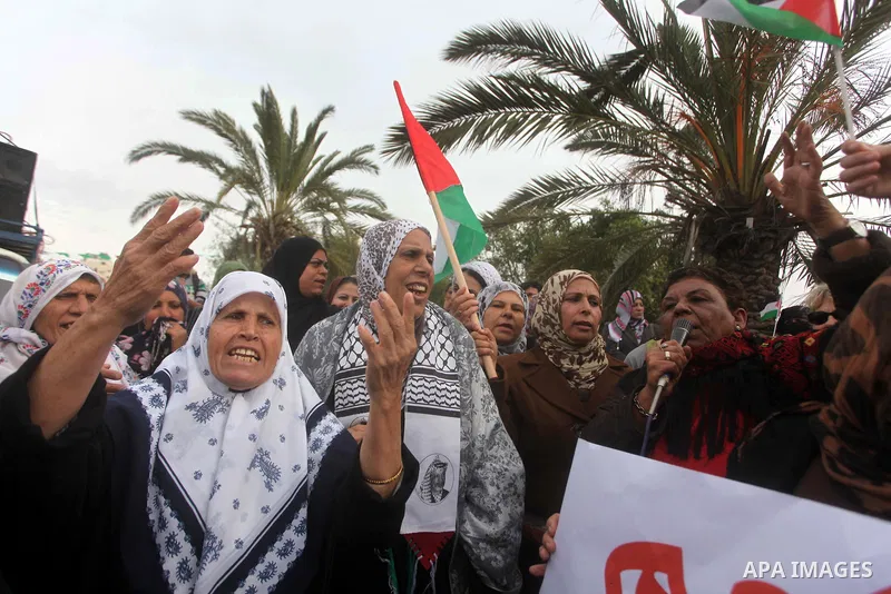 Palestinian women hold national flags during a rally to support reconciliation between rival Palestinian factions in Gaza city on 04 Dec, 2012. Palestinian President Mahmud Abbas pledged Sunday to resume efforts at recon...