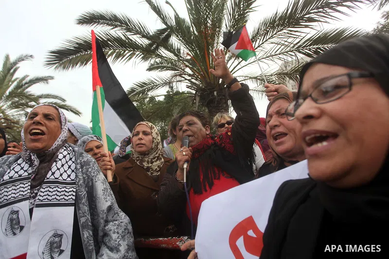 Palestinian women hold national flags during a rally to support reconciliation between rival Palestinian factions in Gaza city on 04 Dec, 2012. Palestinian President Mahmud Abbas pledged Sunday to resume efforts at recon...