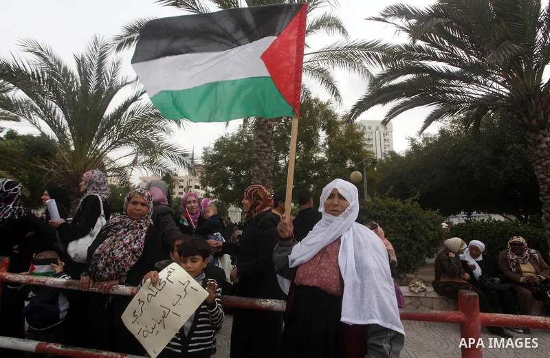 Palestinian women hold national flags during a rally to support reconciliation between rival Palestinian factions in Gaza city on 04 Dec, 2012. Palestinian President Mahmud Abbas pledged Sunday to resume efforts at recon...