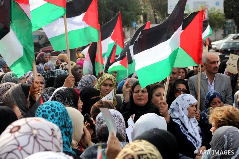 Palestinians hold national flags during a rally to support reconciliation between rival Palestinian factions in Gaza city on 04 Dec, 2012. Palestinian President Mahmud Abbas pledged Sunday to resume efforts at reconcilia...