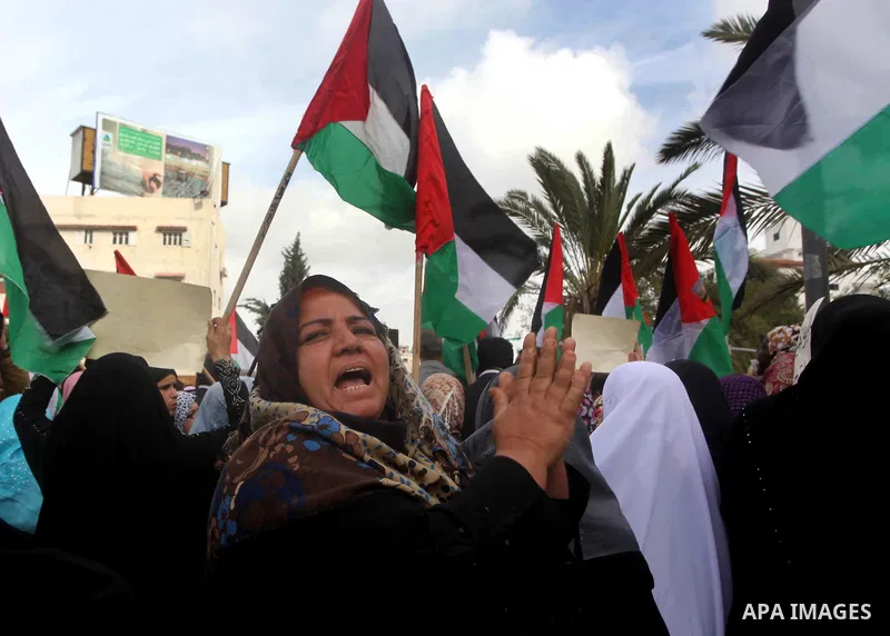 Palestinian women hold national flags during a rally to support reconciliation between rival Palestinian factions in Gaza city on 04 Dec, 2012. Palestinian President Mahmud Abbas pledged Sunday to resume efforts at recon...