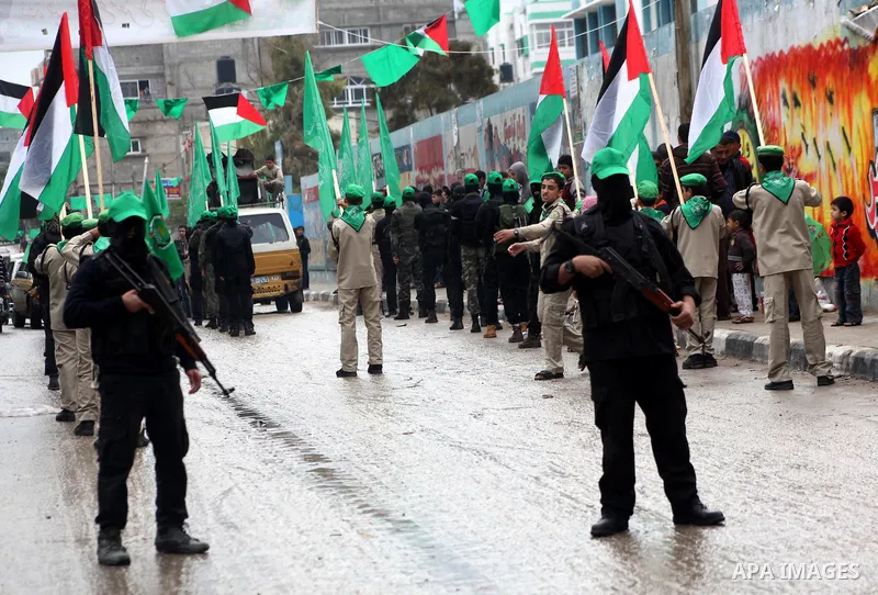 Palestinian members of al-Qassam brigades, the armed wing of the Hamas movement, take part in an anti-Israel parade in Gaza City December 5, 2012. Eight days of Israeli air strikes on Gaza and cross-border Palestinian ro...