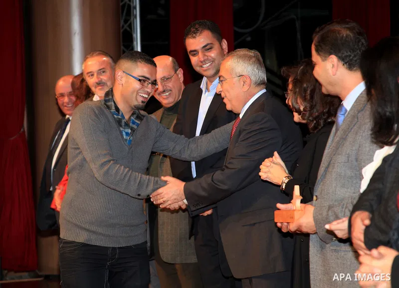 Palestinian Prime Minister Salam Fayyad, attends the national festival for honoring the Palestinian volunteers ?Ounah?, in the West Bank city of Ramallah, on 05 December 2012. Photo by Mustafa Abu Dayeh