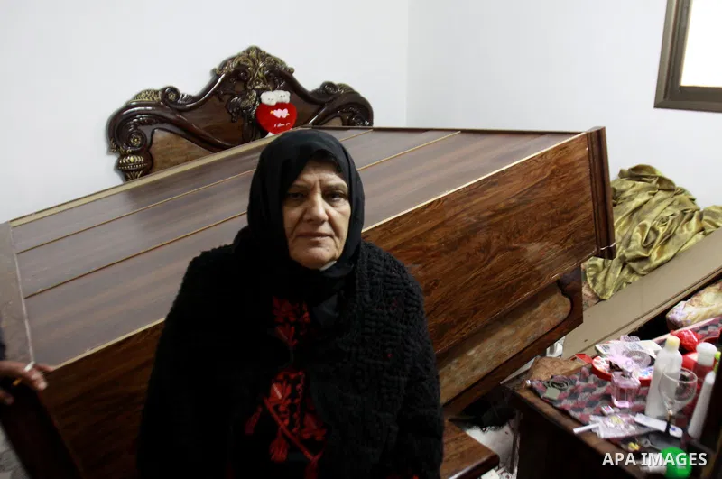 A Palestinian woman inspects her home after the Israeli army operation in search of arms in Burqa village in the West Bank city of Nablus, on Dec. 06, 2012. Photo by Nedal Eshtayah