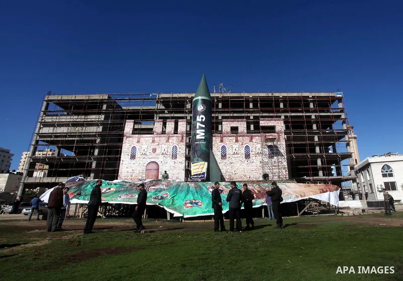 A gigantic model of a locally made M75 rocket is seen on stage during preparations for a Hamas rally in Gaza City on December 6, 2012. Hamas' armed wing said they had fired such a rocket towards Jerusalem and Tel Aviv du...