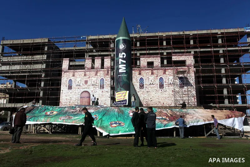 A gigantic model of a locally made M75 rocket is seen on stage during preparations for a Hamas rally in Gaza City on December 6, 2012. Hamas' armed wing said they had fired such a rocket towards Jerusalem and Tel Aviv du...