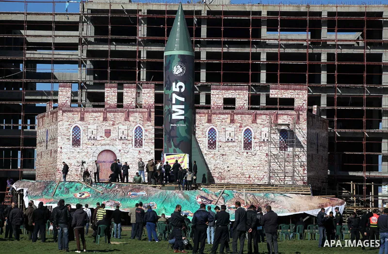 A gigantic model of a locally made M75 rocket is seen on stage during preparations for a Hamas rally in Gaza City on December 6, 2012. Hamas' armed wing said they had fired such a rocket towards Jerusalem and Tel Aviv du...