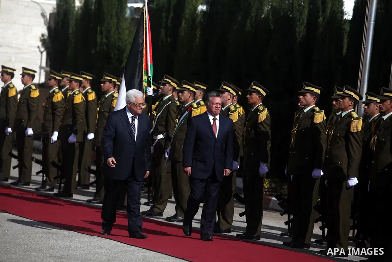 Palestinian president Mahmoud Abbas and Jordanian King Abdullah II review the honour guard during a welcome ceremony upon the latter's arrival in the West Bank city of Ramallah on December 6, 2012. King Abdullah II is th...