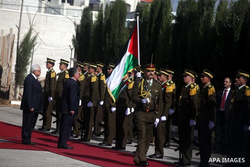 Palestinian president Mahmoud Abbas and Jordanian King Abdullah II review the honour guard during a welcome ceremony upon the latter's arrival in the West Bank city of Ramallah on December 6, 2012. King Abdullah II is th...