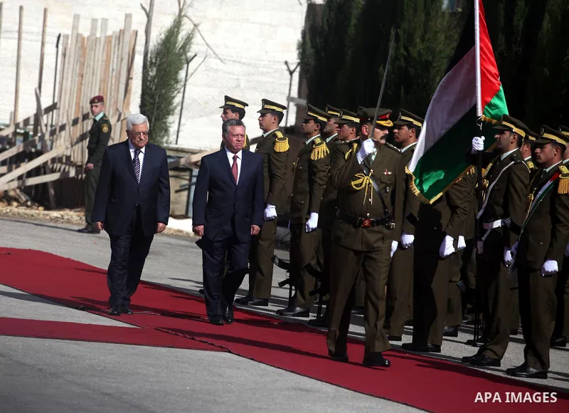 Palestinian president Mahmoud Abbas and Jordanian King Abdullah II review the honour guard during a welcome ceremony upon the latter's arrival in the West Bank city of Ramallah on December 6, 2012. King Abdullah II is th...
