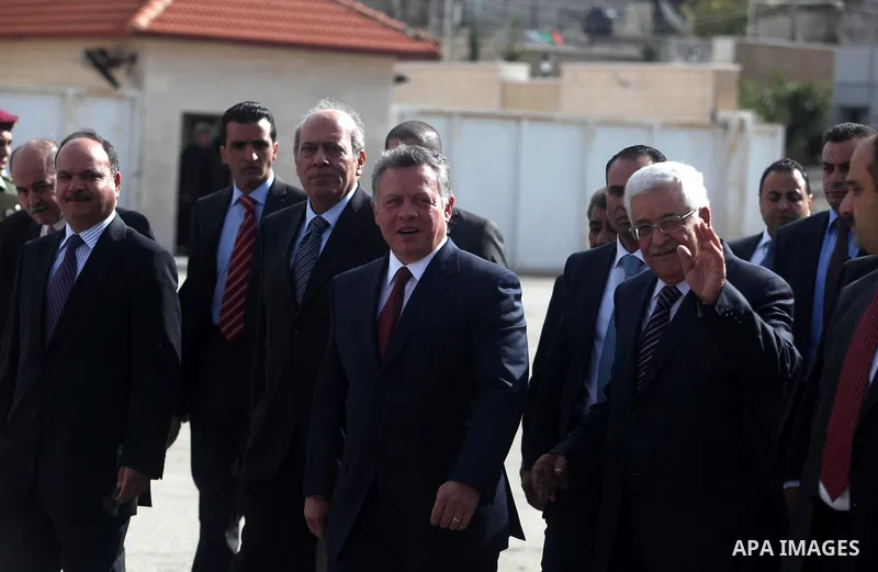Palestinian president Mahmud Abbas (R) waves as he welcomes Jordanian King Abdullah II (C) upon the latter's arrival in the West Bank city of Ramallah on December 6, 2012. King Abdullah II is the first top foreign leader...