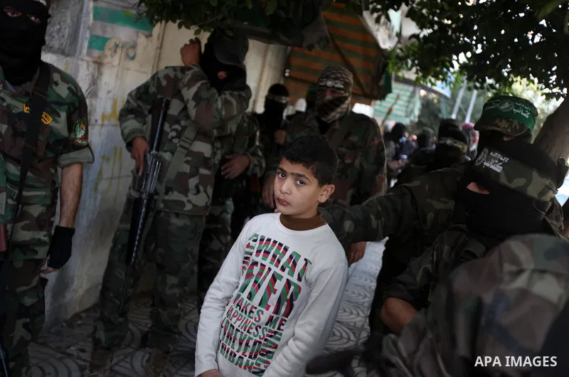 Palestinian militants of the Ezzedine al-Qassam brigade, the armed wing Hamas, attend Friday prayer as they prepare for the arrival of the Islamist movement's exiled politburo chief Khaled Meshaal who is due in the Gaza...