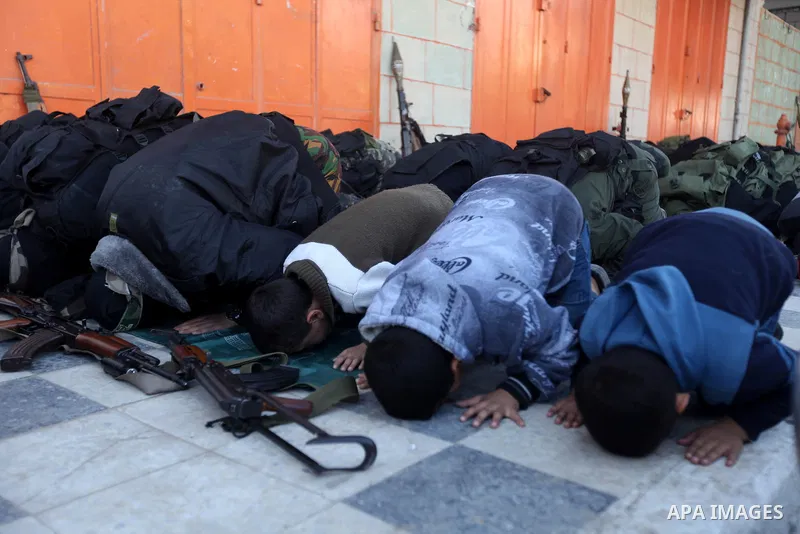 Palestinian militants of the Ezzedine al-Qassam brigade, the armed wing Hamas, attend Friday prayer as they prepare for the arrival of the Islamist movement's exiled politburo chief Khaled Meshaal who is due in the Gaza...