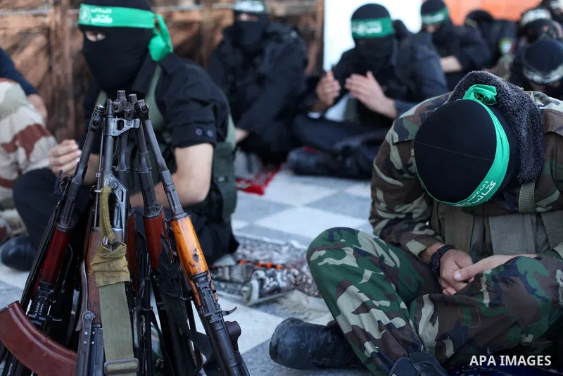 Palestinian militants of the Ezzedine al-Qassam brigade, the armed wing Hamas, attend Friday prayer as they prepare for the arrival of the Islamist movement's exiled politburo chief Khaled Meshaal who is due in the Gaza...