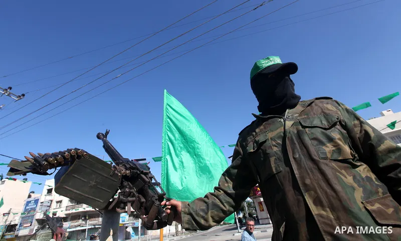 A Palestinian militant of the Ezzedine al-Qassam brigade, the armed wing Hamas, stands guard as they prepare for the arrival of the Islamist movement's exiled politburo chief Khaled Meshaal who is due in the Gaza Strip t...