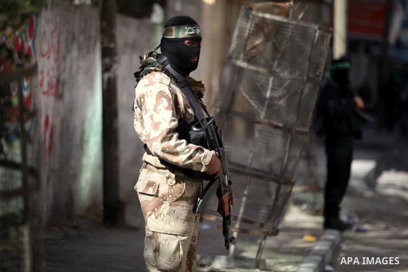 A Palestinian militant of the Ezzedine al-Qassam brigade, the armed wing Hamas, stands guard as they prepare for the arrival of the Islamist movement's exiled politburo chief Khaled Meshaal who is due in the Gaza Strip t...