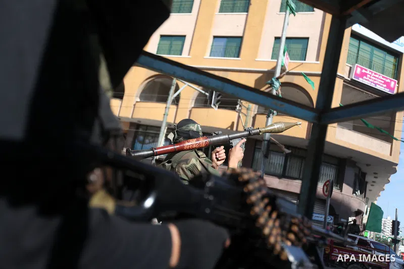 A Palestinian militant of the Ezzedine al-Qassam brigade, the armed wing Hamas, stands guard as they prepare for the arrival of the Islamist movement's exiled politburo chief Khaled Meshaal who is due in the Gaza Strip t...