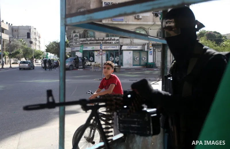 A Palestinian militant of the Ezzedine al-Qassam brigade, the armed wing Hamas, stands guard as they prepare for the arrival of the Islamist movement's exiled politburo chief Khaled Meshaal who is due in the Gaza Strip t...