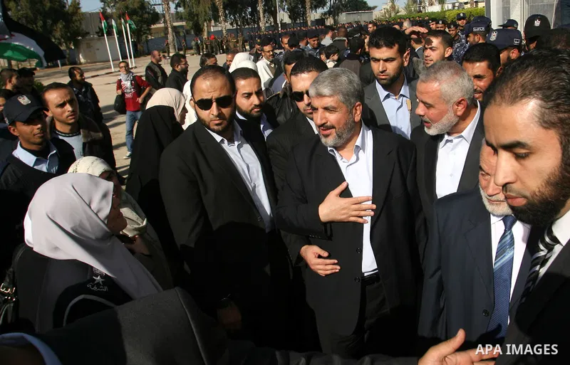 Hamas chief Khaled Meshaal walks with Palestinian prime minister in the Gaza Strip, Ismail Haniya upon Meshaal's arrival in Rafah, southern Gaza, on December 7, 2012. Meshaal is making his first-ever visit to the Gaza St...