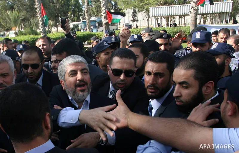 Hamas chief Khaled Meshaal shakes hands with supporters upon his arrival in Rafah, southern Gaza, on December 7, 2012. Meshaal is making his first-ever visit to the Gaza Strip amid tight security for festivities marking...