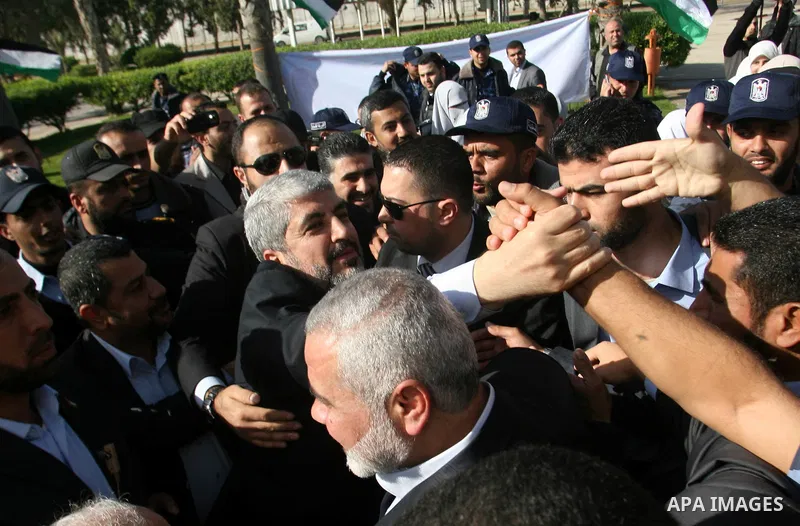 Hamas chief Khaled Meshaal shakes hands with supporters upon his arrival in Rafah, southern Gaza, on December 7, 2012. Meshaal is making his first-ever visit to the Gaza Strip amid tight security for festivities marking...