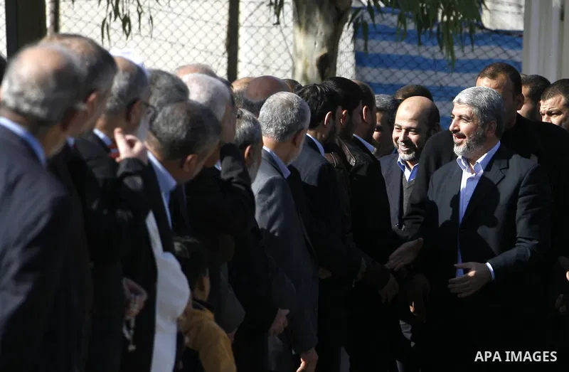 Hamas chief Khaled Meshaal shakes hands with Palestinian leaders upon his arrival in Rafah, southern Gaza, on December 7, 2012. Meshaal is making his first-ever visit to the Gaza Strip amid tight security for festivities...