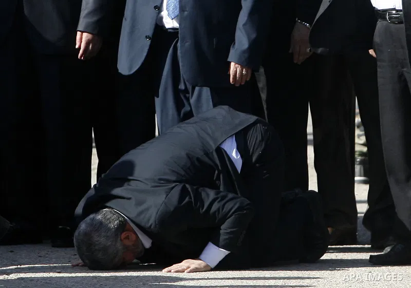 Hamas chief Khaled Meshaal prays, with his head to the ground, upon his arrival in Rafah, southern Gaza, on December 7, 2012. Meshaal is making his first-ever visit to the Gaza Strip amid tight security for festivities m...