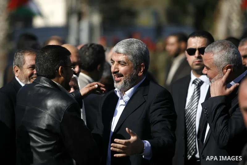 Hamas chief Khaled Meshaal shakes hands with Palestinian leaders upon his arrival in Rafah, southern Gaza, on December 7, 2012. Meshaal is making his first-ever visit to the Gaza Strip amid tight security for festivities...