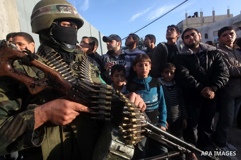 Masked Hamas security men stand guard during a parade following the arrival of Hamas leader-in-exile Khaled Meshaal in Rafah, southern Gaza, on December 7, 2012. Meshaal is making his first-ever visit to the Gaza Strip a...