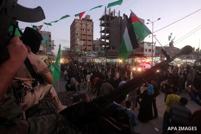 Masked Hamas security men stand guard during a parade following the arrival of Hamas leader-in-exile Khaled Meshaal in Rafah, southern Gaza, on December 7, 2012. Meshaal is making his first-ever visit to the Gaza Strip a...