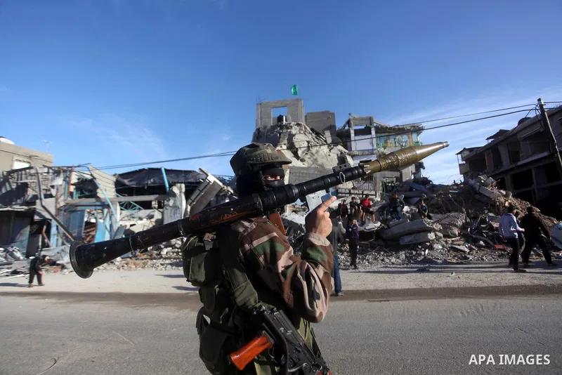 A masked Hamas security man stands guard during a parade following the arrival of Hamas leader-in-exile Khaled Meshaal in Rafah, southern Gaza, on December 7, 2012. Meshaal is making his first-ever visit to the Gaza Stri...