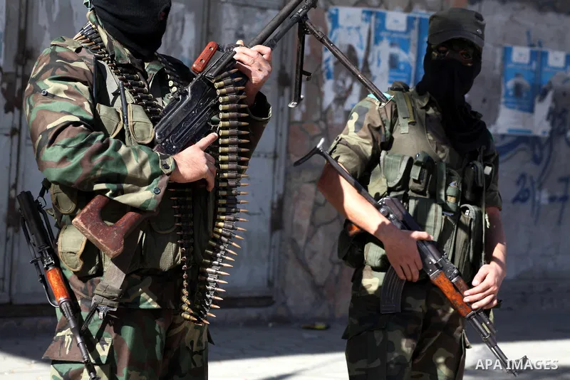 Masked Hamas security men stand guard during a parade following the arrival of Hamas leader-in-exile Khaled Meshaal in Rafah, southern Gaza, on December 7, 2012. Meshaal is making his first-ever visit to the Gaza Strip a...