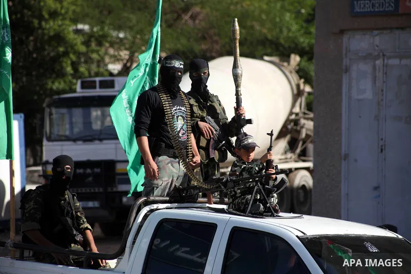 Masked Hamas security men stand guard during a parade following the arrival of Hamas leader-in-exile Khaled Meshaal in Rafah, southern Gaza, on December 7, 2012. Meshaal is making his first-ever visit to the Gaza Strip a...