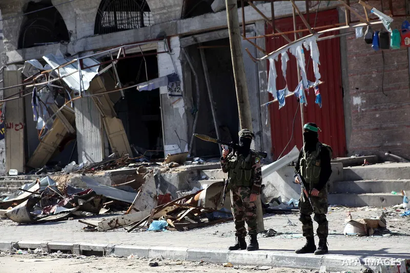 Masked Hamas security men stand guard during a parade following the arrival of Hamas leader-in-exile Khaled Meshaal in Rafah, southern Gaza, on December 7, 2012. Meshaal is making his first-ever visit to the Gaza Strip a...