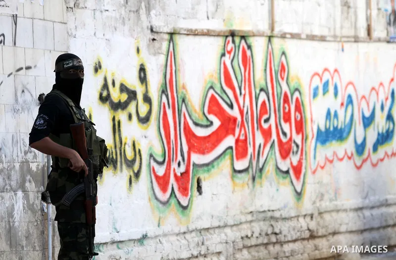 A Palestinian militant of the Ezzedine al-Qassam brigade, the armed wing Hamas, stands guard as they prepare for the arrival of the Islamist movement's exiled politburo chief Khaled Meshaal who is due in the Gaza Strip t...