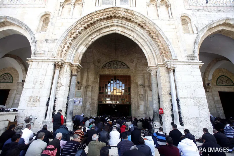 Palestinian Muslim worshippers pray outside the Dome of the Rock at al-Aqsa mosque compound, Islam's third holiest site, on December 7, 2012. Photo by Mahfouz Abu Turk