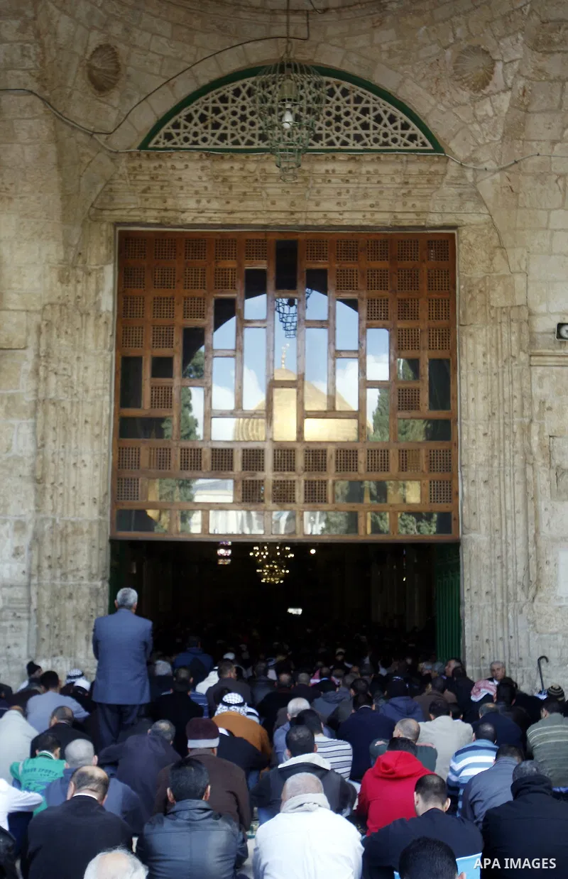 Palestinian Muslim worshippers pray outside the Dome of the Rock at al-Aqsa mosque compound, Islam's third holiest site, on December 7, 2012. Photo by Mahfouz Abu Turk