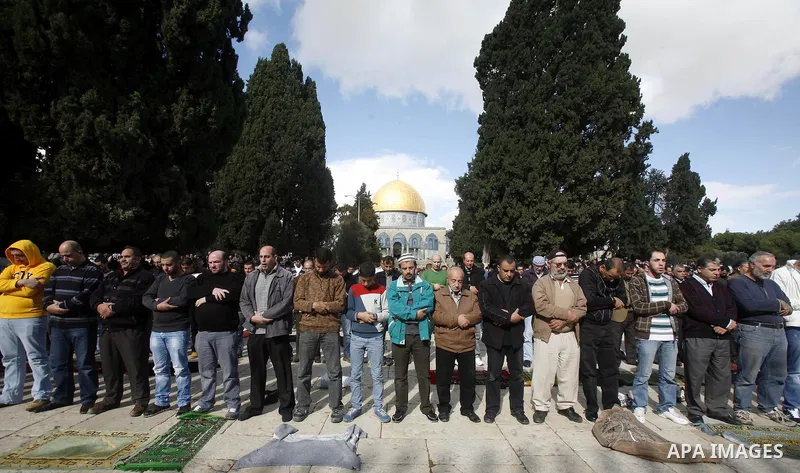 Palestinian Muslim worshippers pray outside the Dome of the Rock at al-Aqsa mosque compound, Islam's third holiest site, on December 7, 2012. Photo by Mahfouz Abu Turk