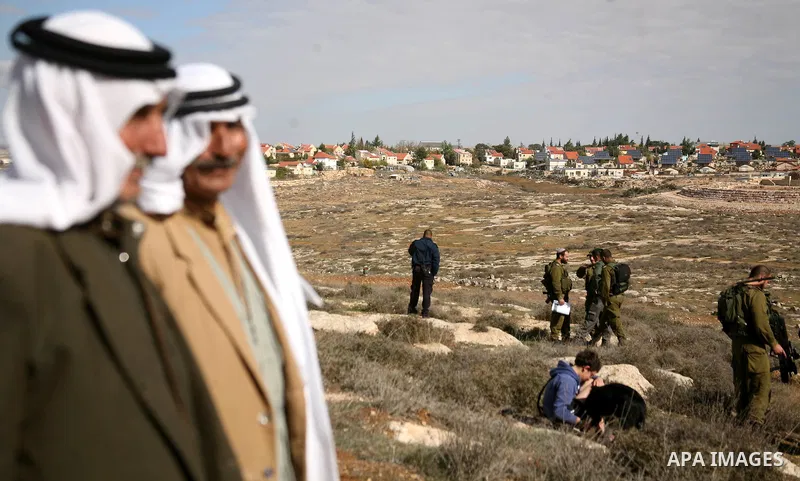 Israel soldiers stand guards as they prevent Palestinians from reaching their farming lands near the Jewish settlement of Sosia in the West Bank city of Hebron on December 7,2012. Israel intends to carry out extensive bu...